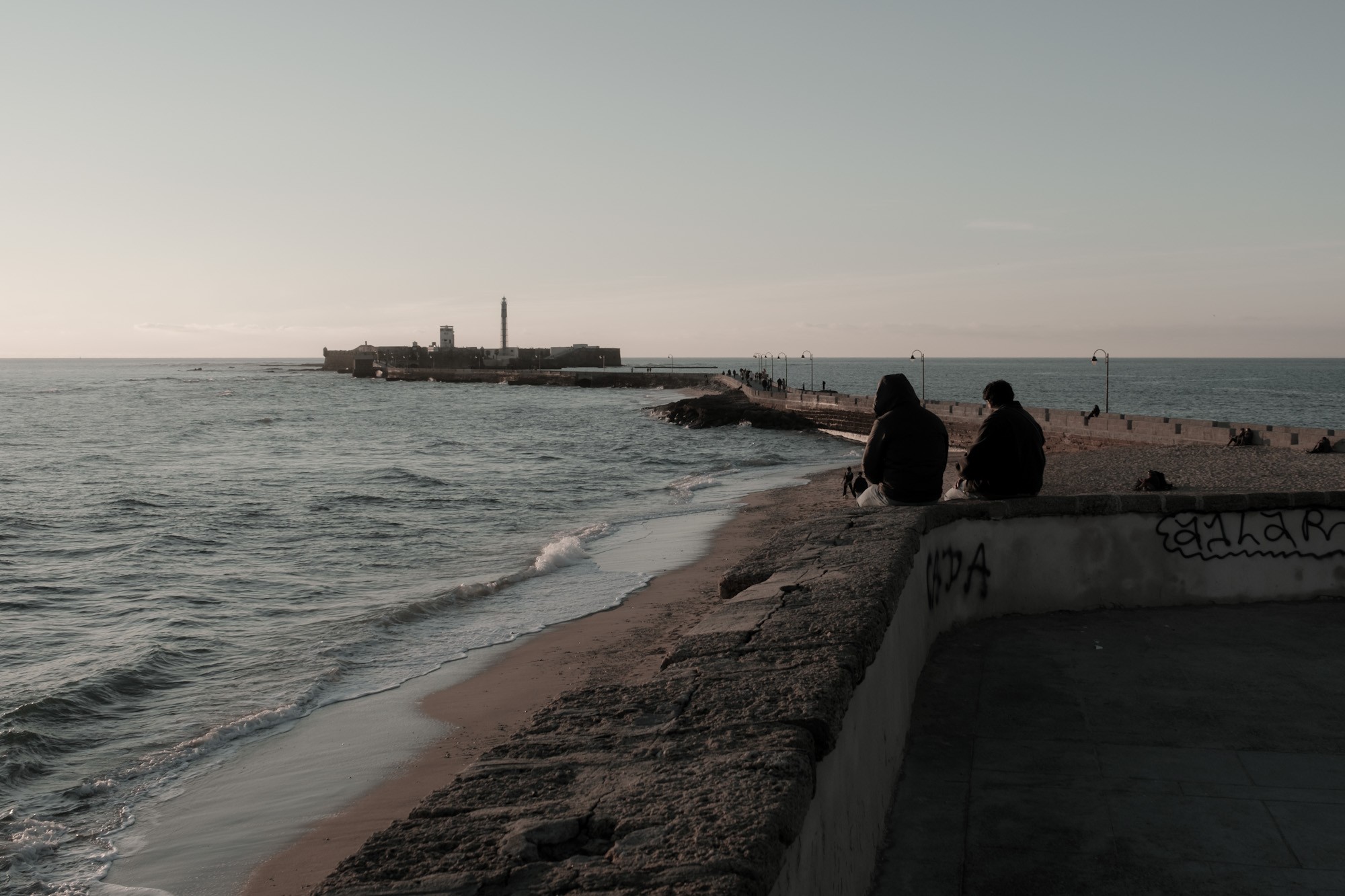 People relaxing at sunset in Cadiz Andalusia