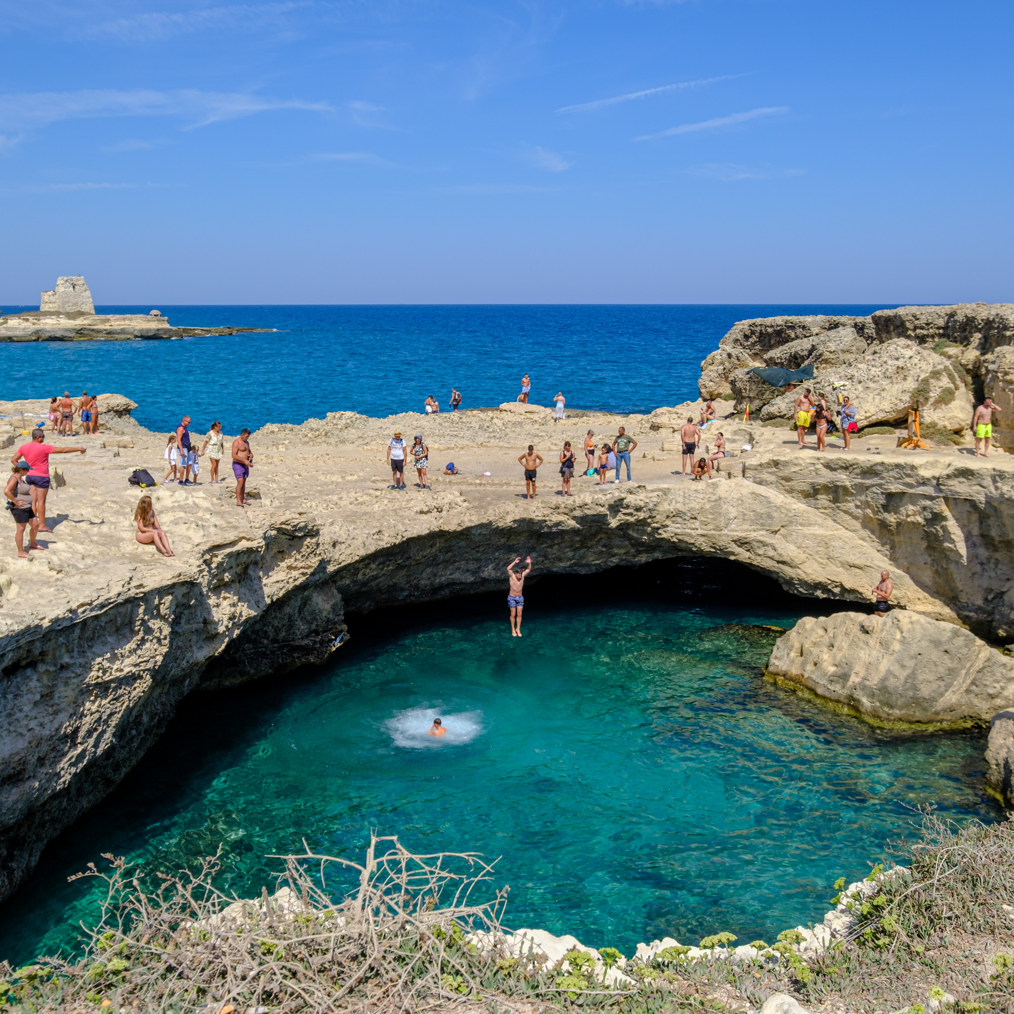 People having fun at the Grotta della Poesia in Puglia