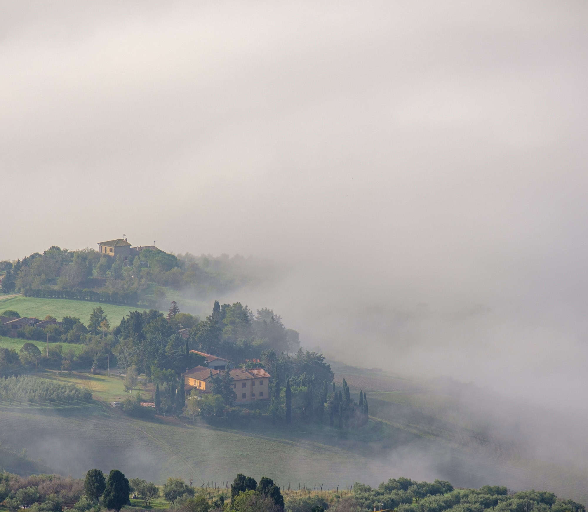 Morning fog covering the valleys near Volterra Tuscany
