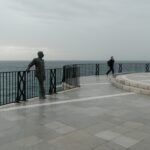 Solo turist in Balcon Europa during a cloudy day in Nerja Spain