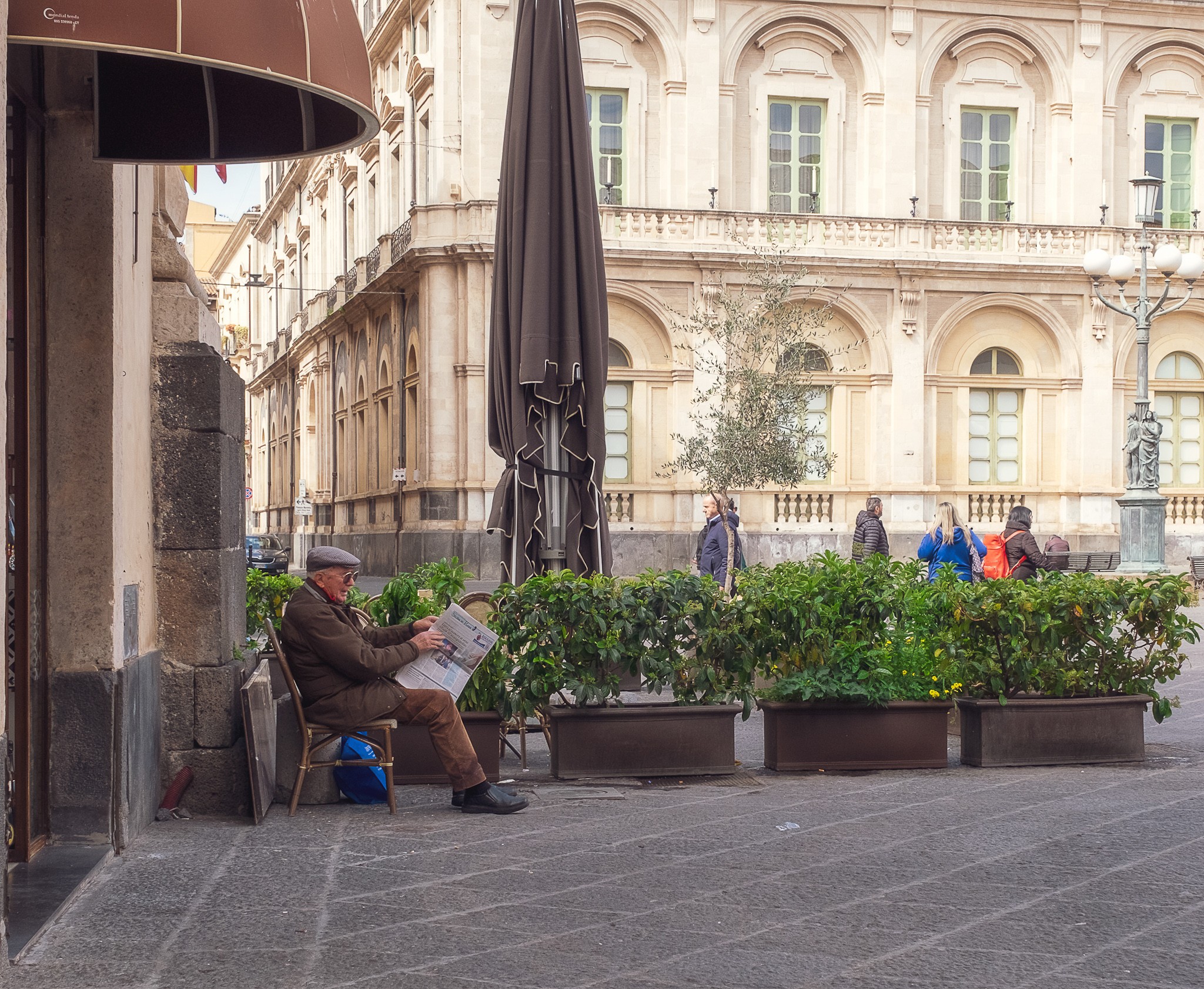 Old man reading the paper in Catania Sicily