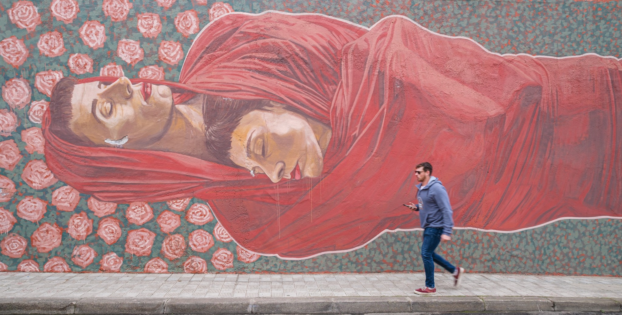 People walking by murals in Tenerife